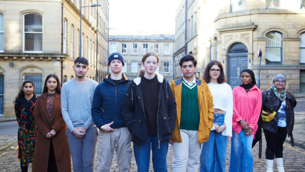 A group of young people stand in a line in a Bradford street