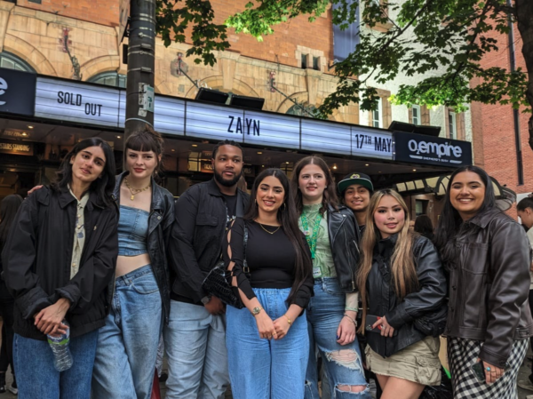 A group of young people stand outside the O2 Shepherd's Bush Empire before Zayn Malik's first solo show.