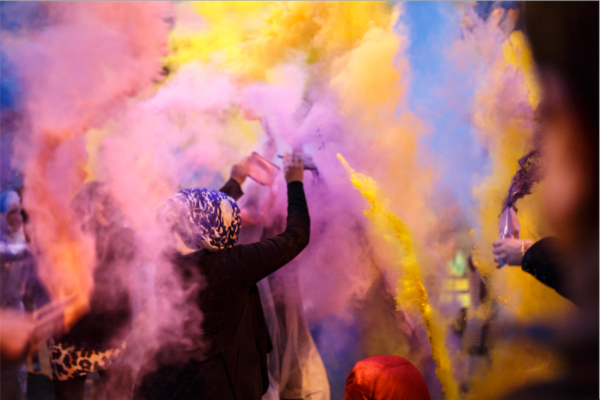 A woman throwing paint during Holi festival celebrations