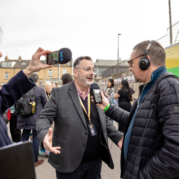 Executive Director Dan Bates with members of the press