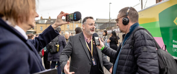 Executive Director Dan Bates with members of the press