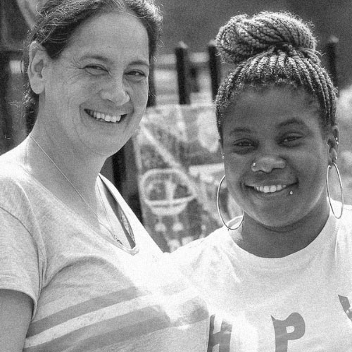 A black and white image of two women smiling.