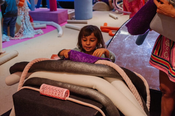 Young person playing with foam structures.