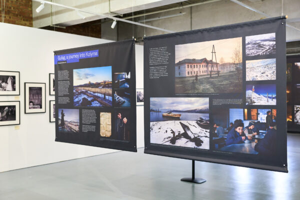 Photos hanging from the ceiling in panels