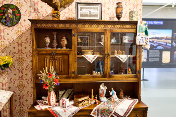 A set within the gallery - an old fashioned hutch littered with family memorabilia.