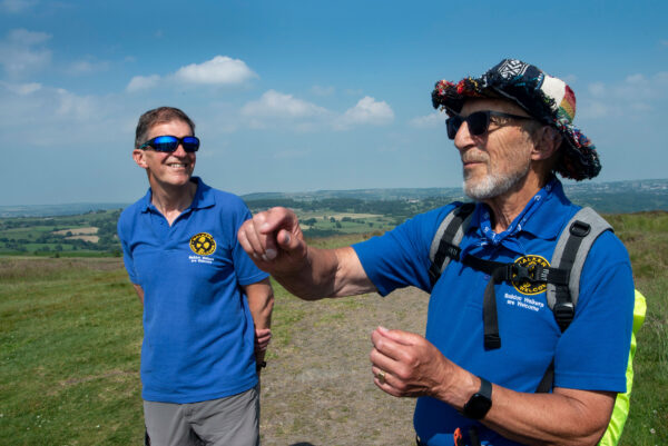 Two men from Baildon Walkers Are Welcome chat in the Bradford countryside.