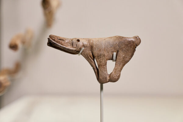A carved animal mounted on a plinth