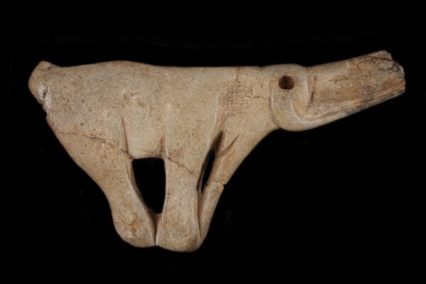 A piece of carved bone depicting a mammoth spear thrower