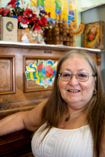 A woman sits in front of a piano.