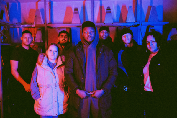 Group image of young adults in a red and blue light