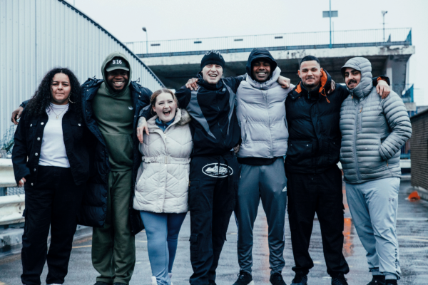 Group of young adults hugging together outside