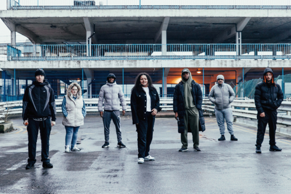 Group image of young adults stood on top of a car park roof