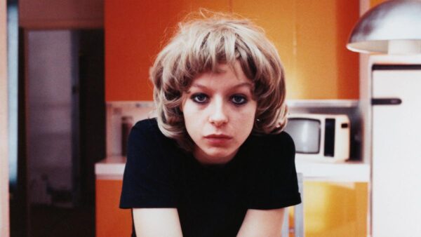 A woman stares at the camera with a serious expression. A still from the film Under the Skin.