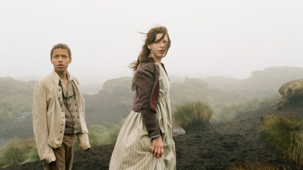 Two people stand on a windy moor. A still from the film Wuthering Heights.