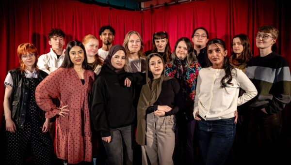 A group of young people standing in a line.