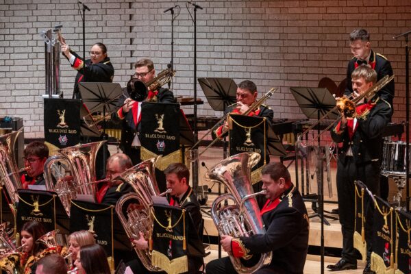 A brass band plays together for a concert