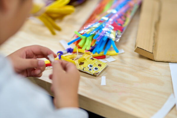 Close up shot of a participant's hands in a craft workshop.