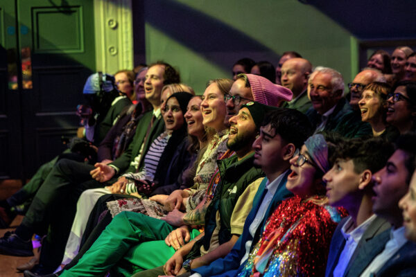 A group of audience members smiling.