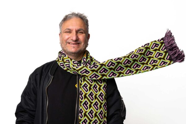 A model smiles wearing a Bradford 2025 scarf.