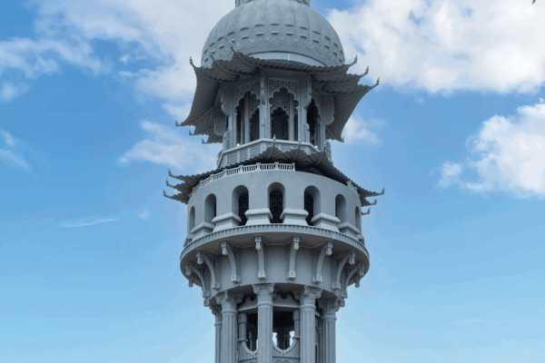Tower of Now sculpture. A large outdoor grey sculpture with different architectural designs to represent different cultures