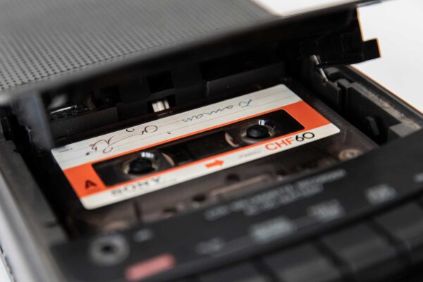 A close up of a cassette tape and player.