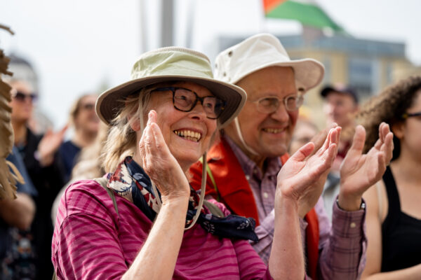 People happily clap along to the band.