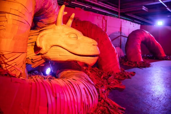 Red and orange crafted dragon made form cardboard asleep in a cardboard enchanted experience