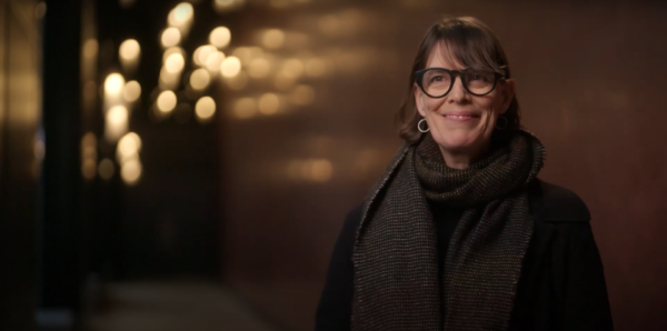 Headshot of lady (Clio Barnard), short brown hair with a fridge and large round glasses