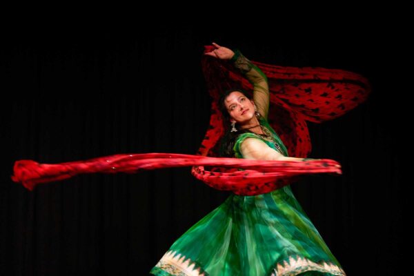 A woman dances in traditional Indian dress