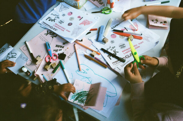 A film photo of people's hands doing crafts.
