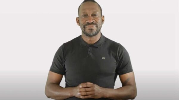 A man holding his hands together in front of him