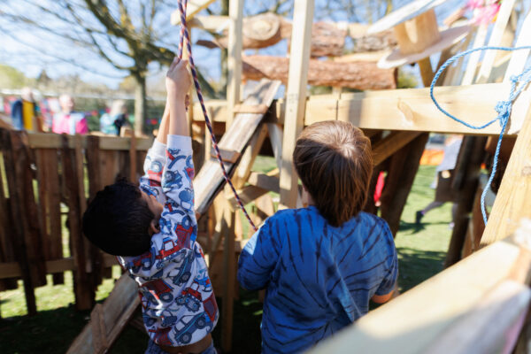 Children building a wooden den