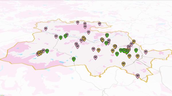 A pink and white map of Bradford District covered in small pins.