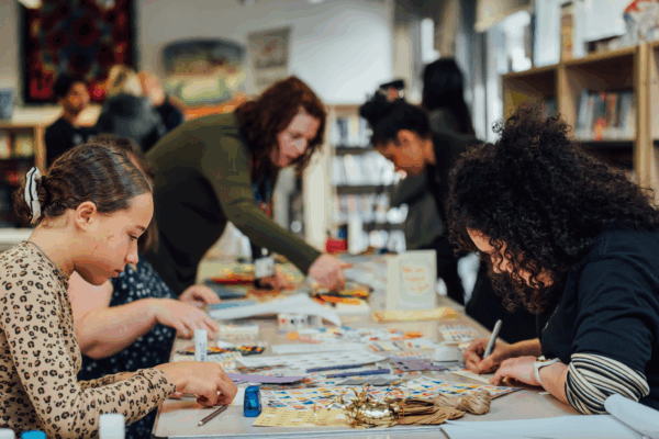 Adults help children with a craft activity
