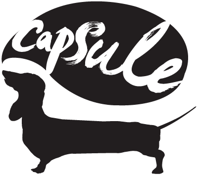 Black and white logo - a dauschund with a speech bubble: Capsule