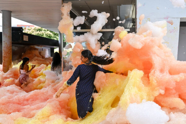 Girl playing in orange coloured foam.