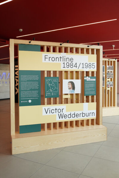 Brightly coloured interpretation is mounted on wooden boards - introducing the exhibition.