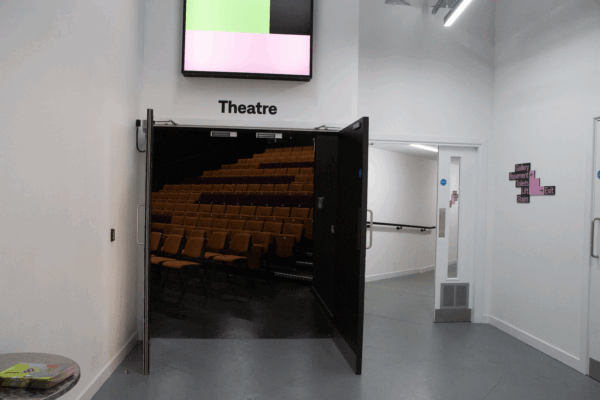 double doors open to the entrance to the theatre