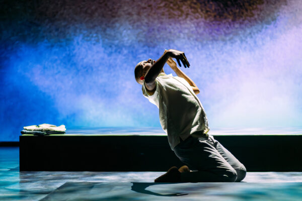 man on his knees falling backwards