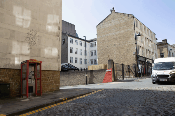 An outdoor street and tall sand buildings