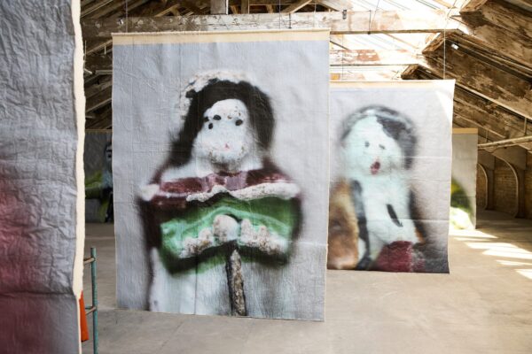 Large pieces of art / paintings hanging in a large room