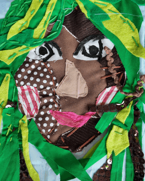 A colourful textile self-portrait with green hair.