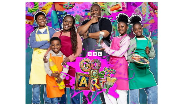 A family wearing colourful clothes and aprons holding art materials such as paintbrushes and art palettes