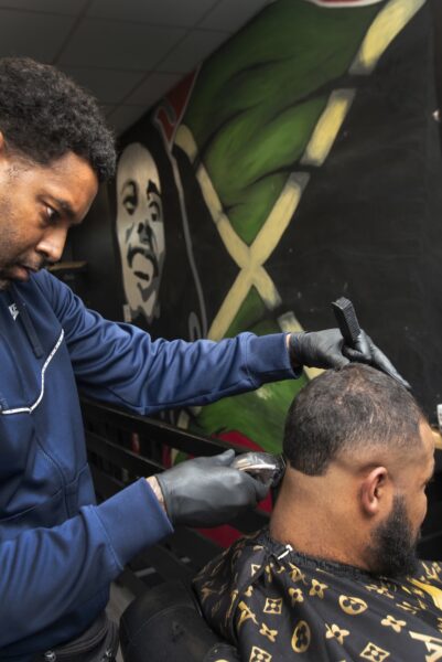 man getting his hair cut in a barbers shop