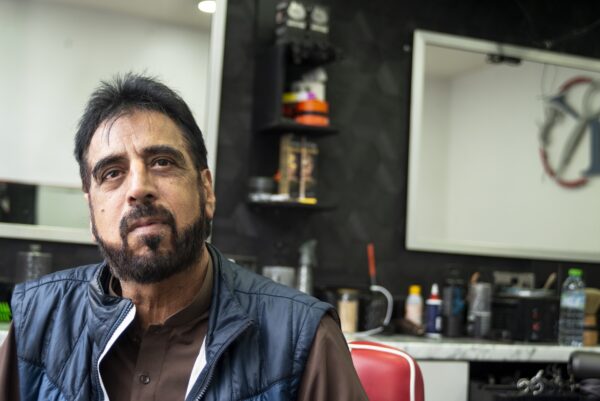 man sat in barbers