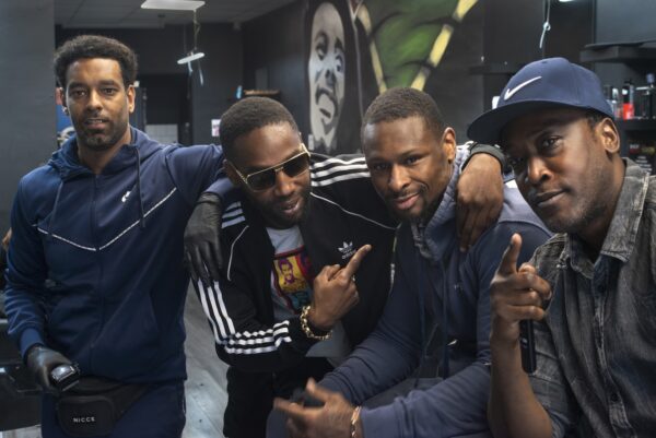 Raphael Fontaine (far left) with customers at New Vision Barbers in Bradford City Centre.