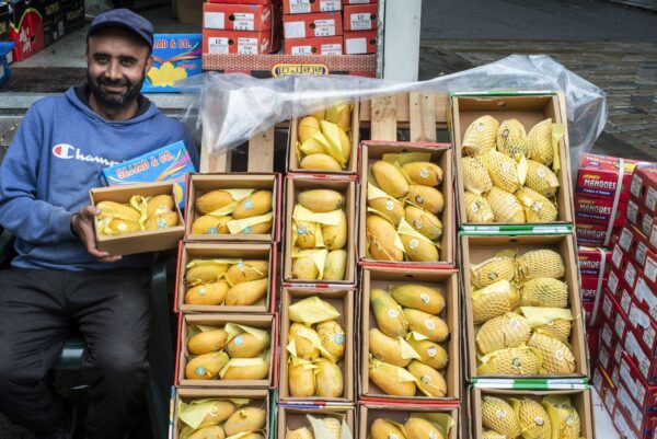 Anon Pakistani mango seller and his wares in Manningham. Photo by Tim Smith.
