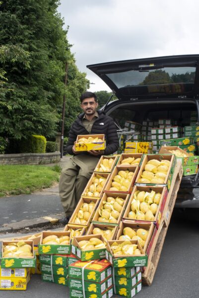 Karida, a Pakistani mango seller and his wares in Shipley. Photo by Tim Smith.