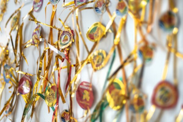 Stickers and tinsel from Pakistani mangos stuck to a fridge door. Photo by Tim Smith.