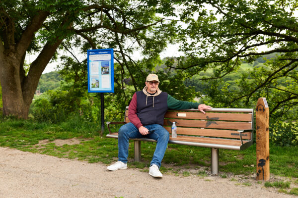 man sat on a bench outside